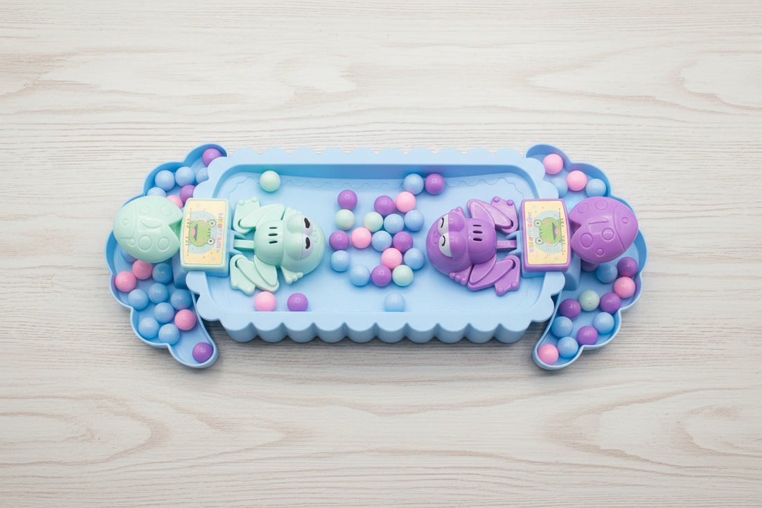 Overhead view of Frogs Subsonic Tabletop Game board with colorful pastel balls and frog launchers on a wooden table