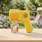 10 Holes Yellow Bubble Gun with a clear bottle of bubble solution sits on a wooden table outdoors, with bubbles floating around it and a blurred garden background.