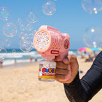 10 Holes Pink Bubble Gun with bubbles on a beach