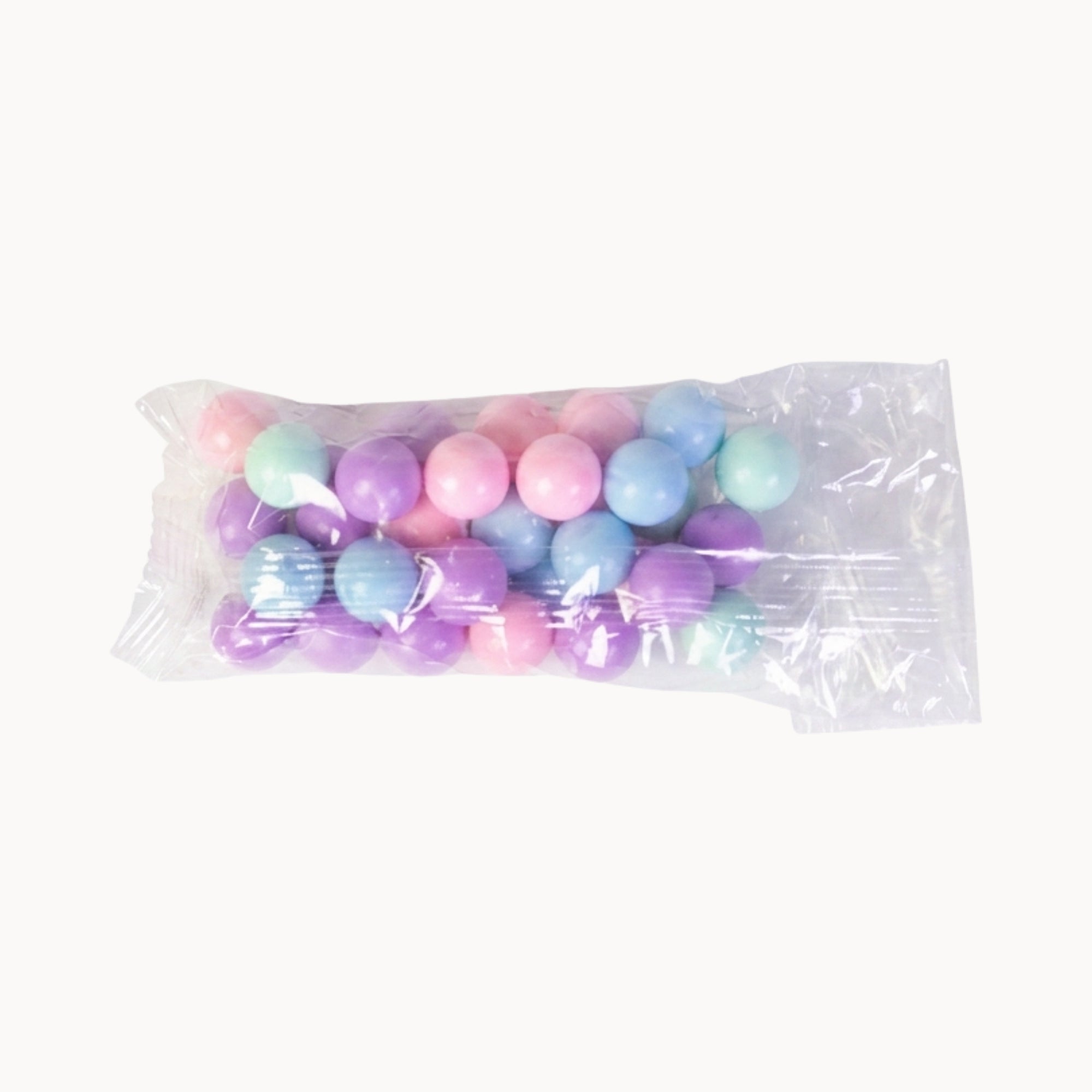 Bag of pastel-colored balls on a white background